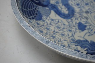 A large Japanese blue and white decorated charger, 47cm diameter. Condition - riveted and chips to rim